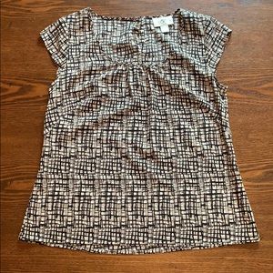 Black, cream and white blouse with short sleeves.